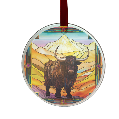round stain-glass looking ornament featuring a bull with horns in front of a mountain background