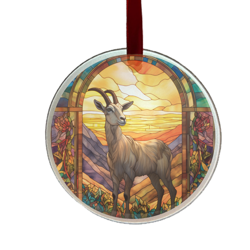 A round glass ornament featuring an illustration of a goat in a stained glass style design, with a vibrant sunset background.