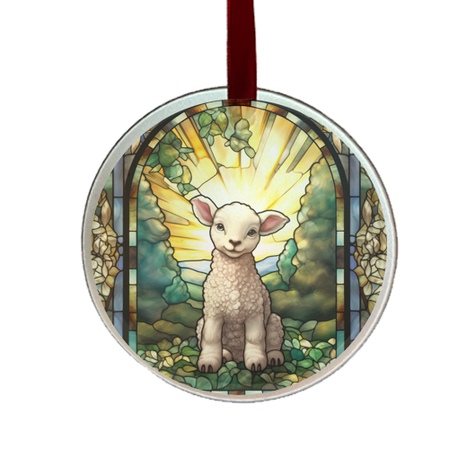 A round glass ornament with a stained glass design featuring a lamb, trees, and a sun motif.