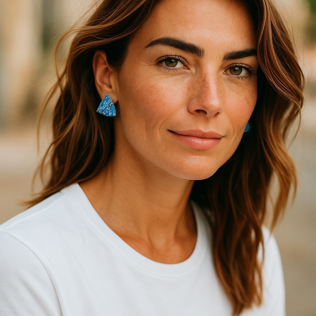 woman wearing blue ocean wave stud earrings