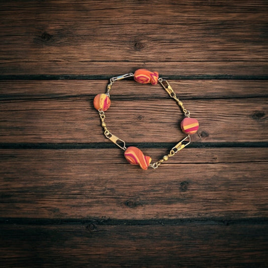 Bracelet with colorful goldfish beads on a wooden surface
