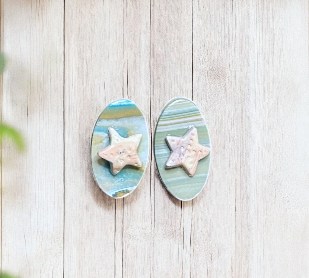 oval shaped starfish polymer clay earrings with ocean themed background